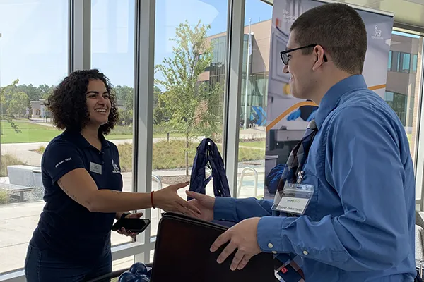 A student meets with a prospective employer during a career fair.