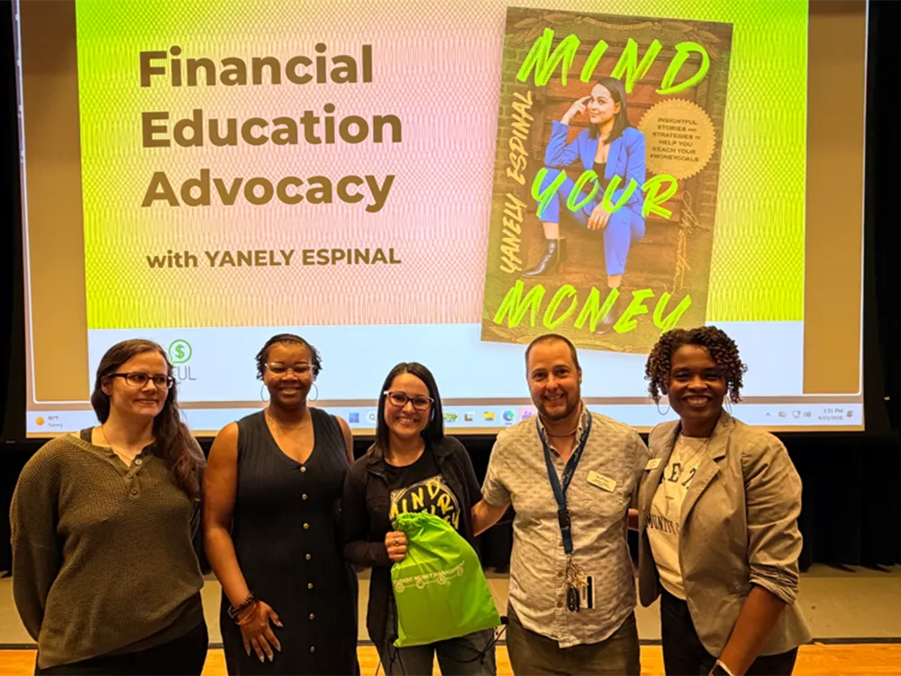 A money management expert poses for a photo with Wake Tech administrators.
