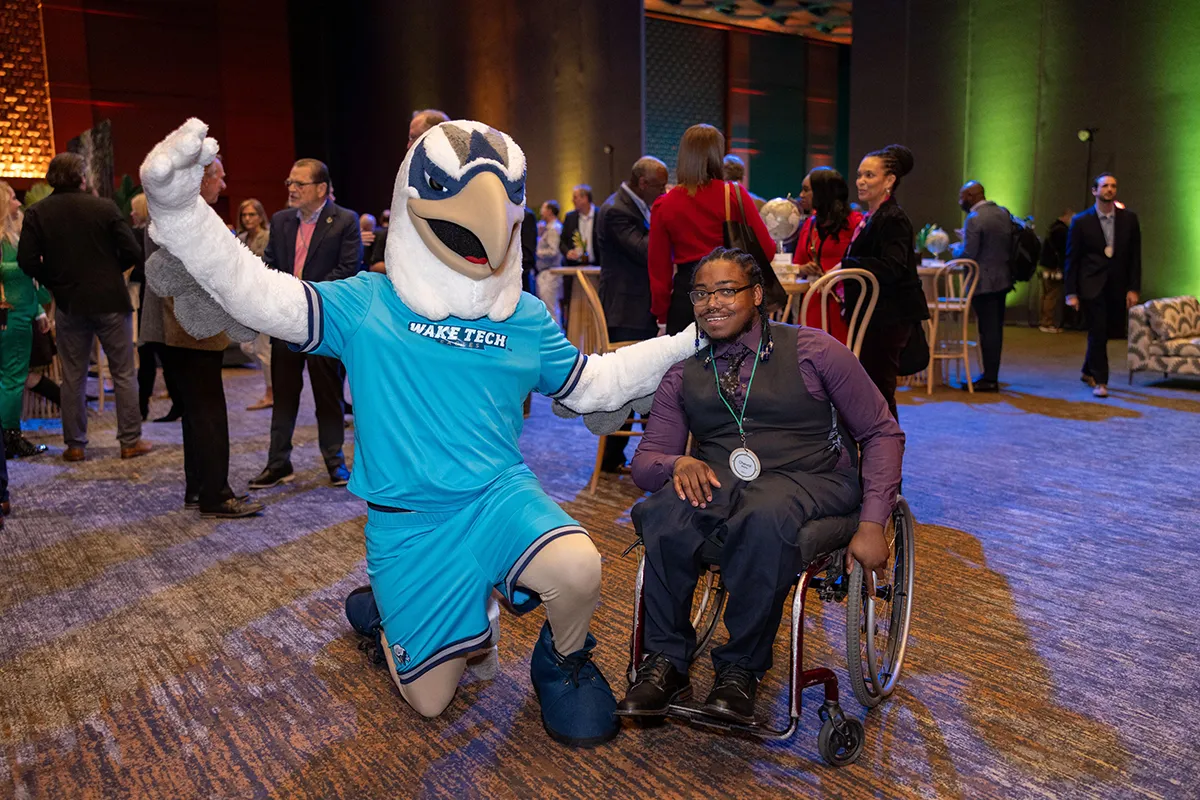 Talon, Wake Tech's eagle mascot, poses with Cheval Batts, one of the students honored at the 2025 Wake Tech IGNITE event.