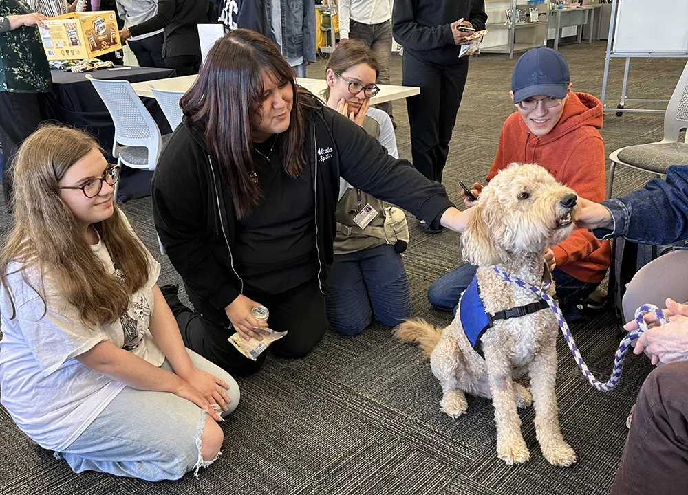 A therapy dog helps students get a break from studying.