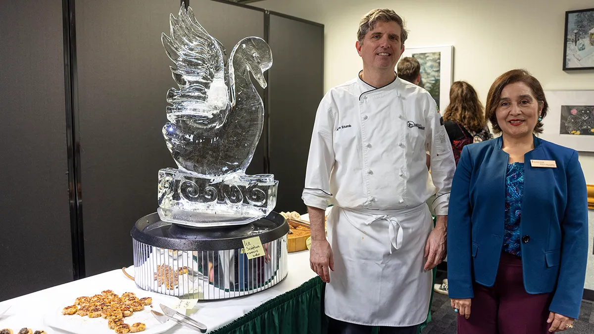 Chef Aaron Stumb with Melania Aguiree-Rabon, Foreign Languages and Fine Arts department head, at the opening-night reception for a juried art exhibition at Wake Tech.