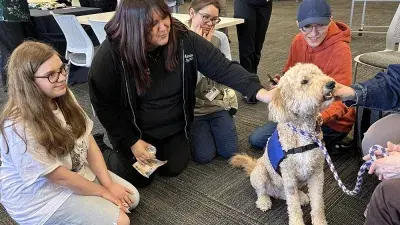 A therapy dog helps students get a break from studying.