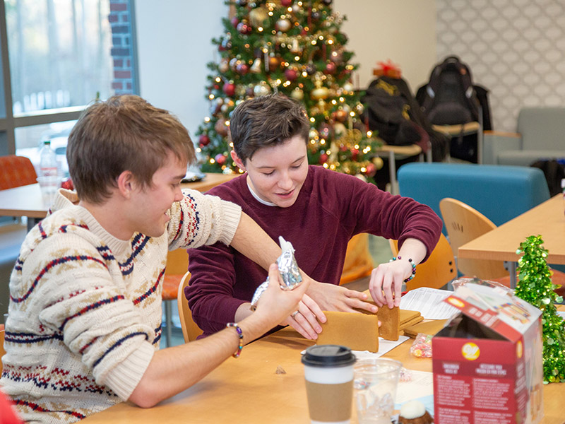 Student Ambassadors try their hands at building a gingerbread house