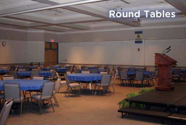A layout with round tables in the Conference Center on Southern Wake Campus