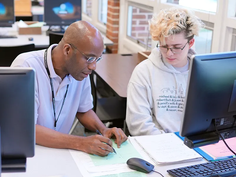 A Tutoring and Learning Center tutor helps a Wake Tech student.