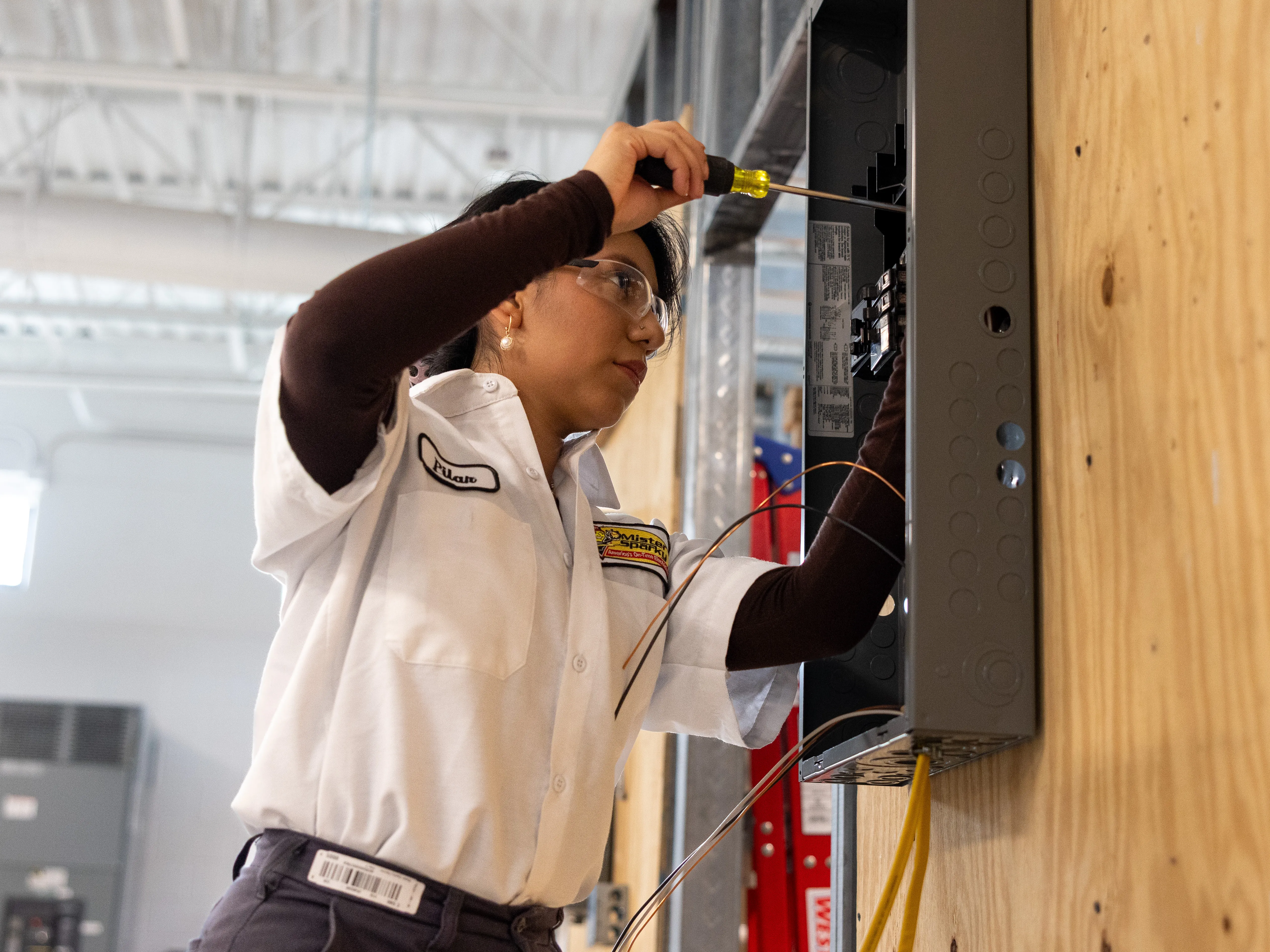 Wake Tech student working on an electrical box
