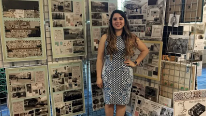 A Wake Tech Interior Design student displays work she completed at the annual Interior Design Showcase.