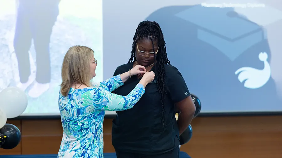 A Wake Tech Pharmacy Technology student gets pinned in the annual pinning ceremony.
