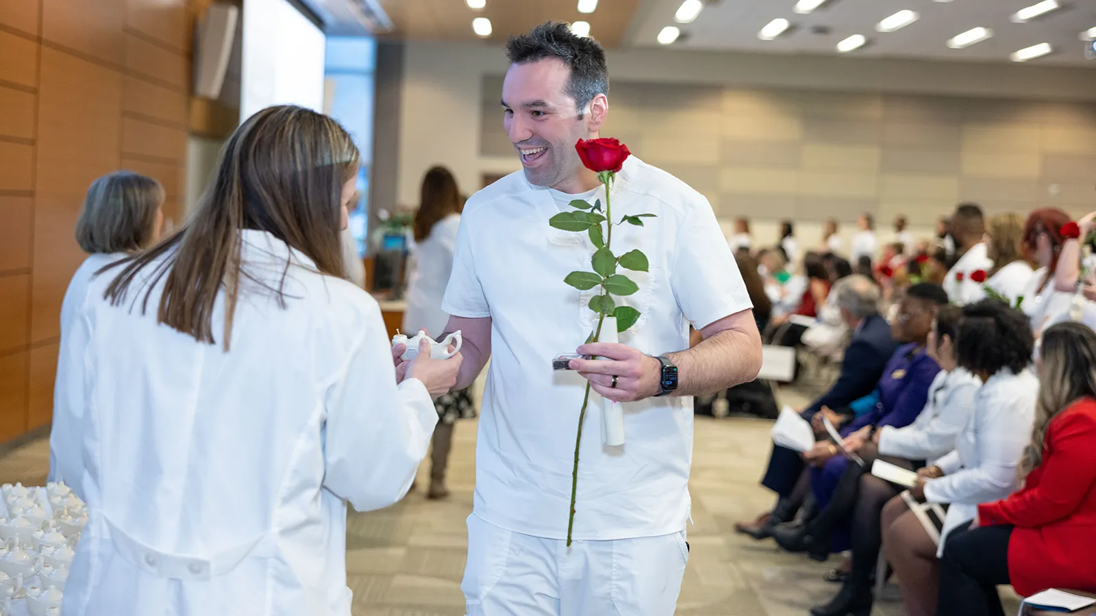 A Nursing graduate receives his pin at the annual pinning ceremony.