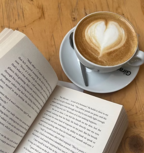 Cup of coffee next to a book