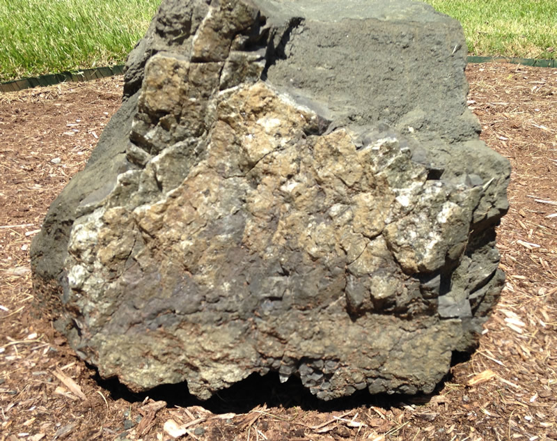 Figure 5a: Two images of sides of different diabase boulders. You can see that the boulders have a roughly rectangular prism shape, which is due to how this rock contracts (and therefore breaks) as it cools from molten lava.