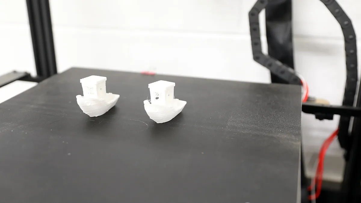Two printed toy boats in a 3D printer in the makerspace on Southern Wake Campus