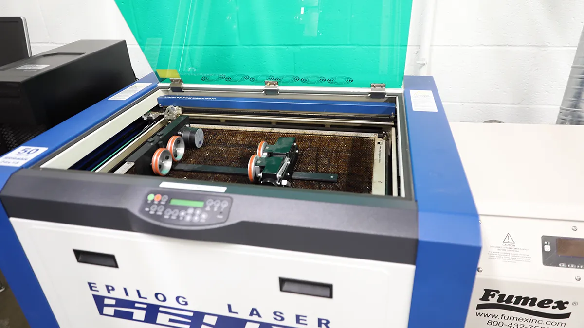 An opened Epilog Laser laser engraver and cutter in the makerspace on Southern Wake Campus
