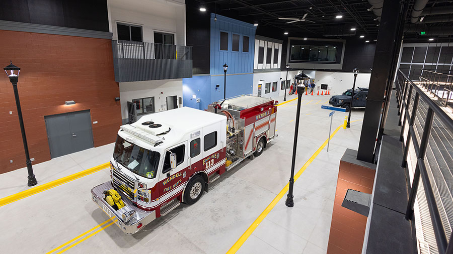 A fire engine is parked on the immersive streetscape for public safety training simulations.