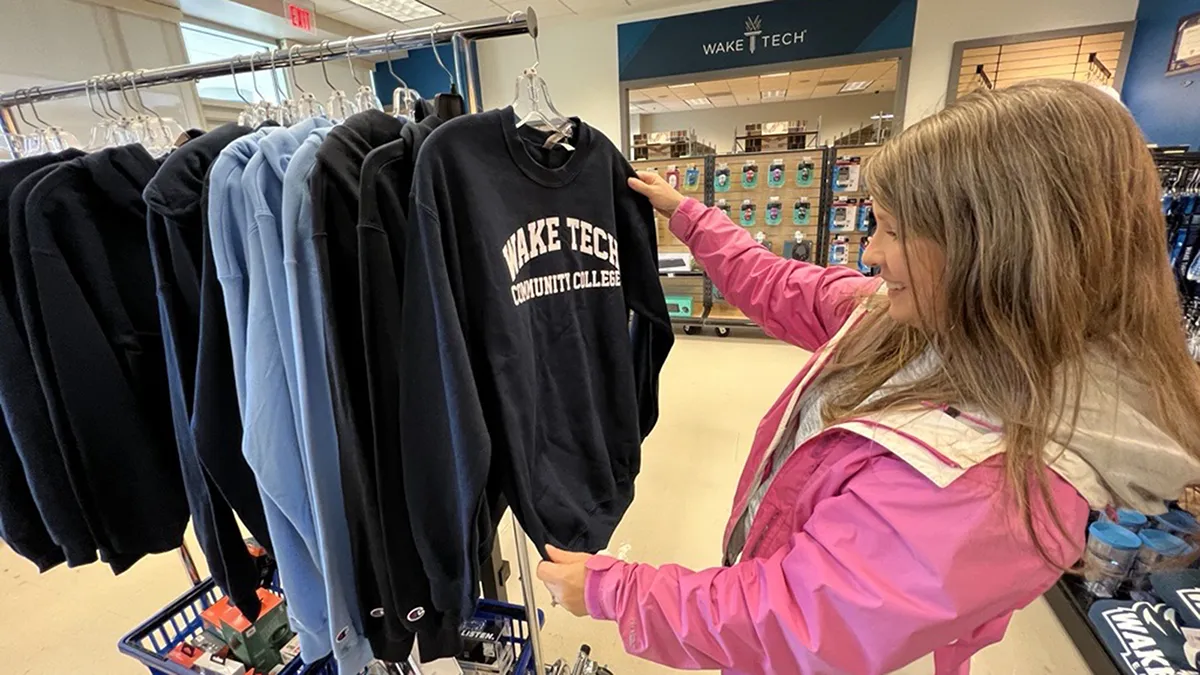 A student checks out Wake Tech branded sweatshirts.