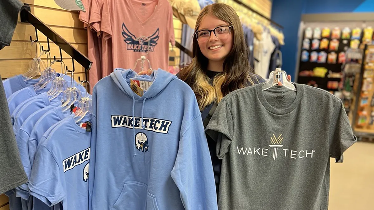 A student checks out Wake Tech branded shirts.
