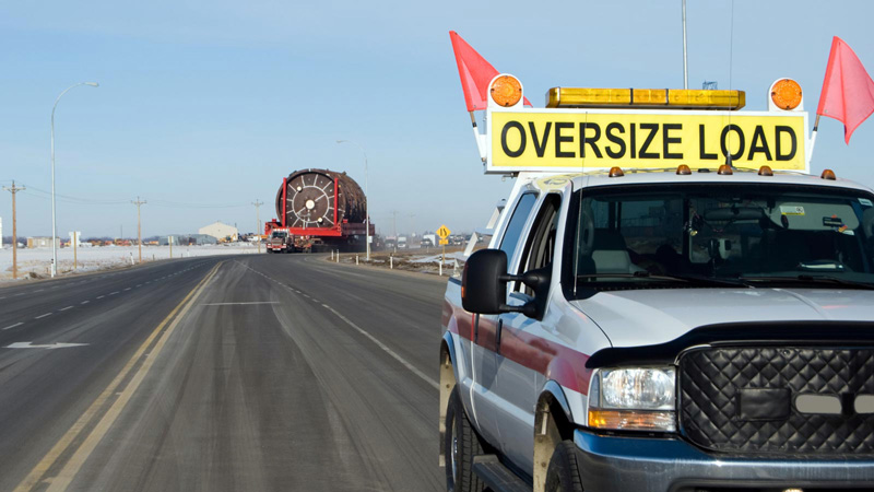 Escort vehicle for wide load truck on highway