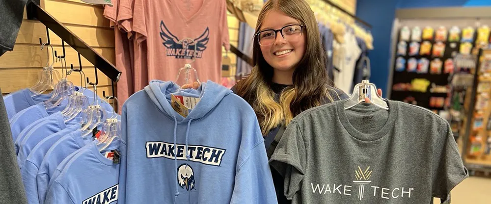 Student showing off her Wake Tech shirts