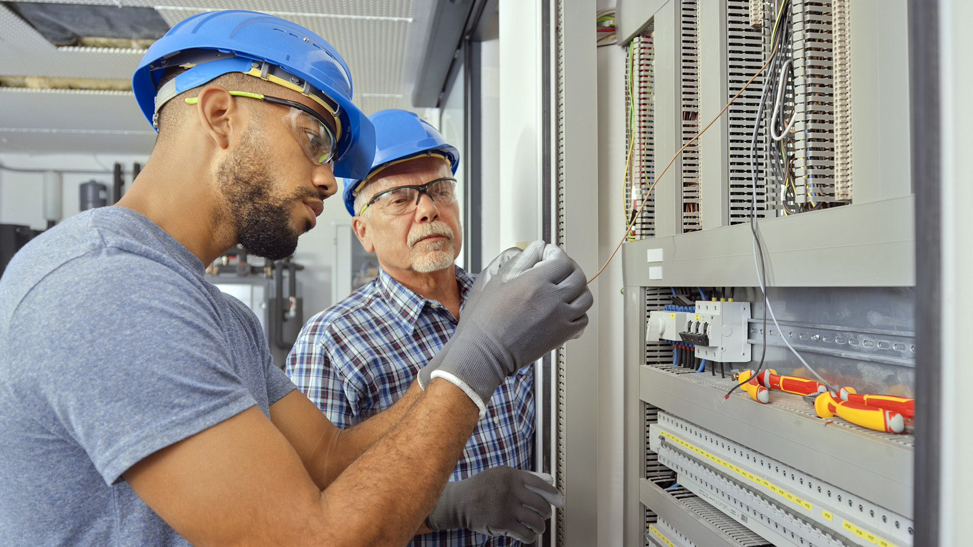 An apprentice electrician learns about wiring