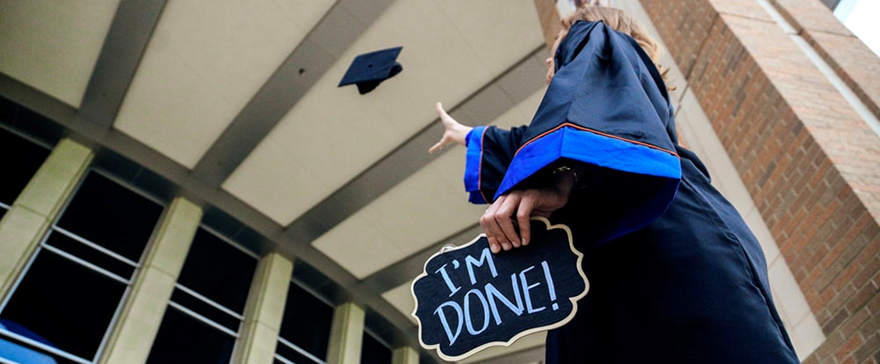 college graduate tossing mortarboard
