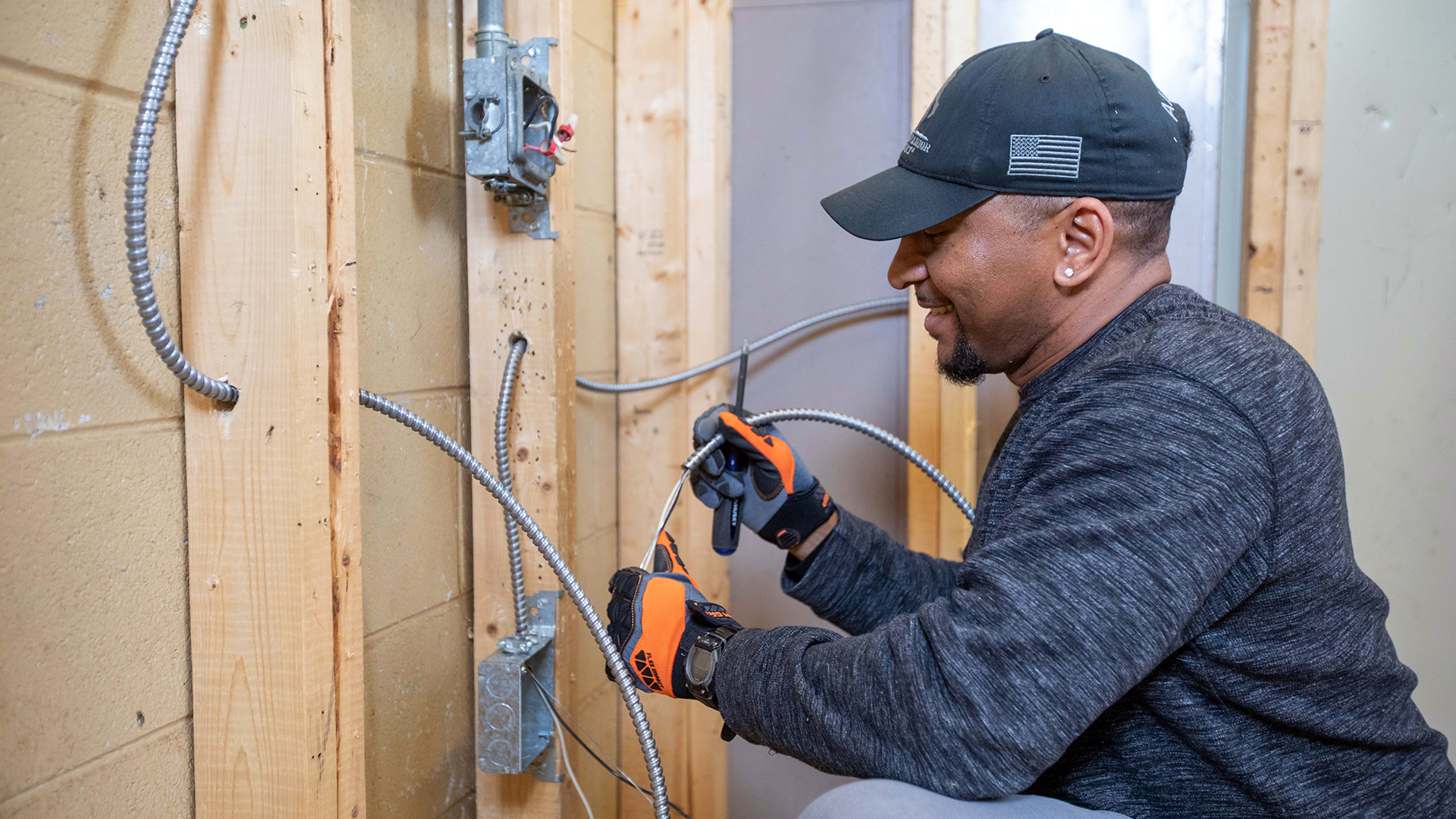 Worker installing electrical wiring