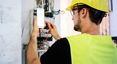 Worker testing fiber-optic line