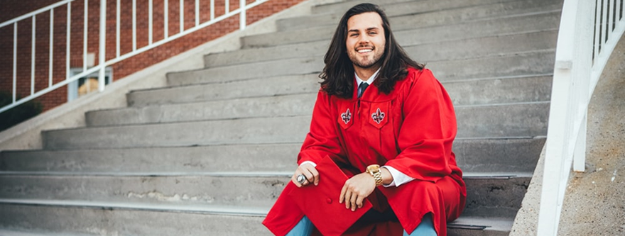 A smiling college graduate