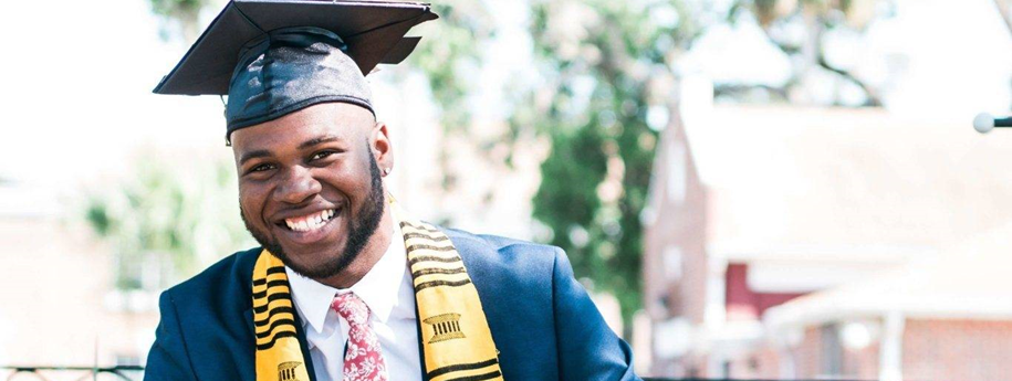 A smiling college graduate