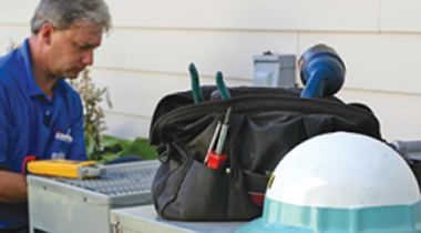 Worker repairing air conditioning unit