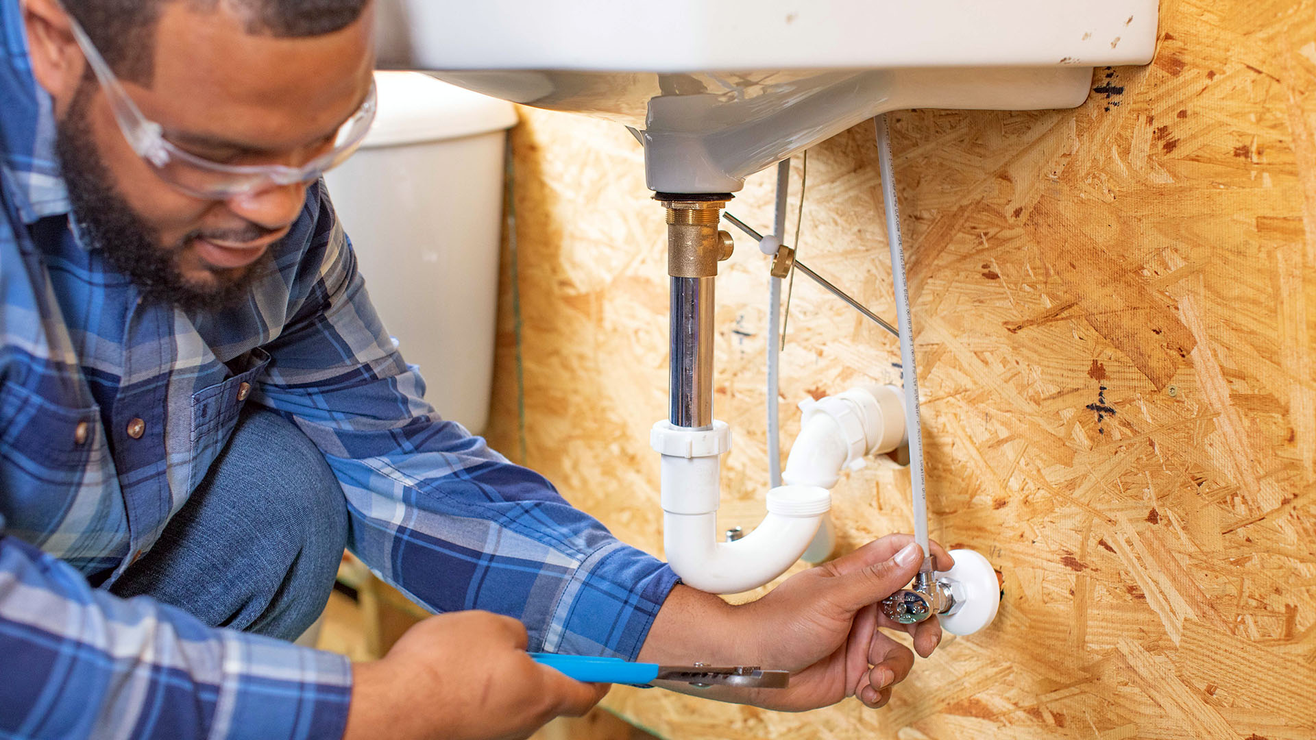 Plumber fixing sink drain