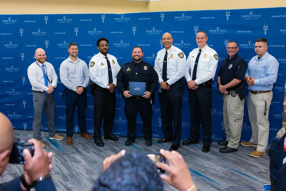 Members of the latest class to graduate from Wake Tech's Basic Law Enforcement Training Academy pose for a photo.