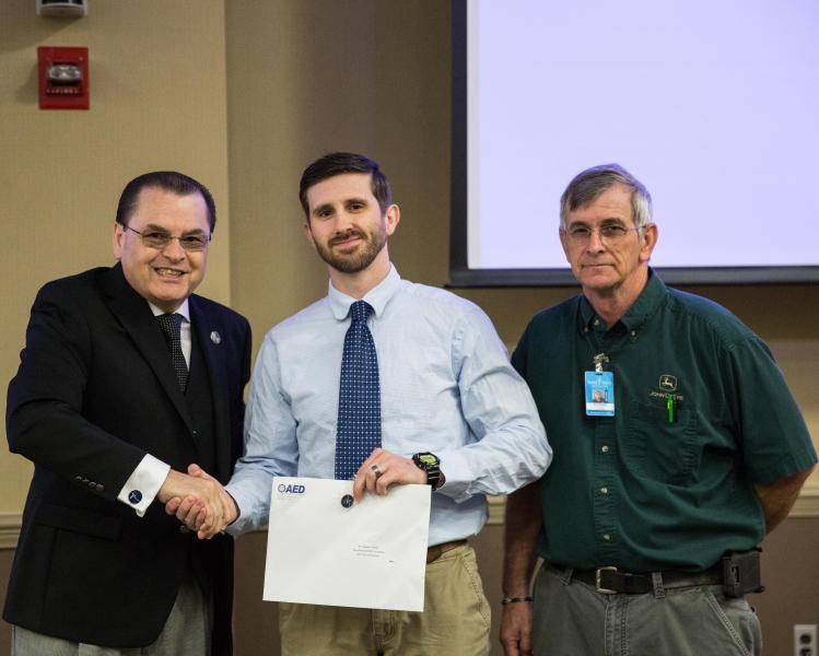 Dr. Stephen Scott, Wake Tech President; Joshua Schmidt, student; Ronnie Lowe, Heavy Equipment & Transport Technology