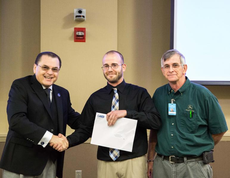 Dr. Stephen Scott, Wake Tech President; Joshua Schmidt, student; Ronnie Lowe, Heavy Equipment & Transport Technology