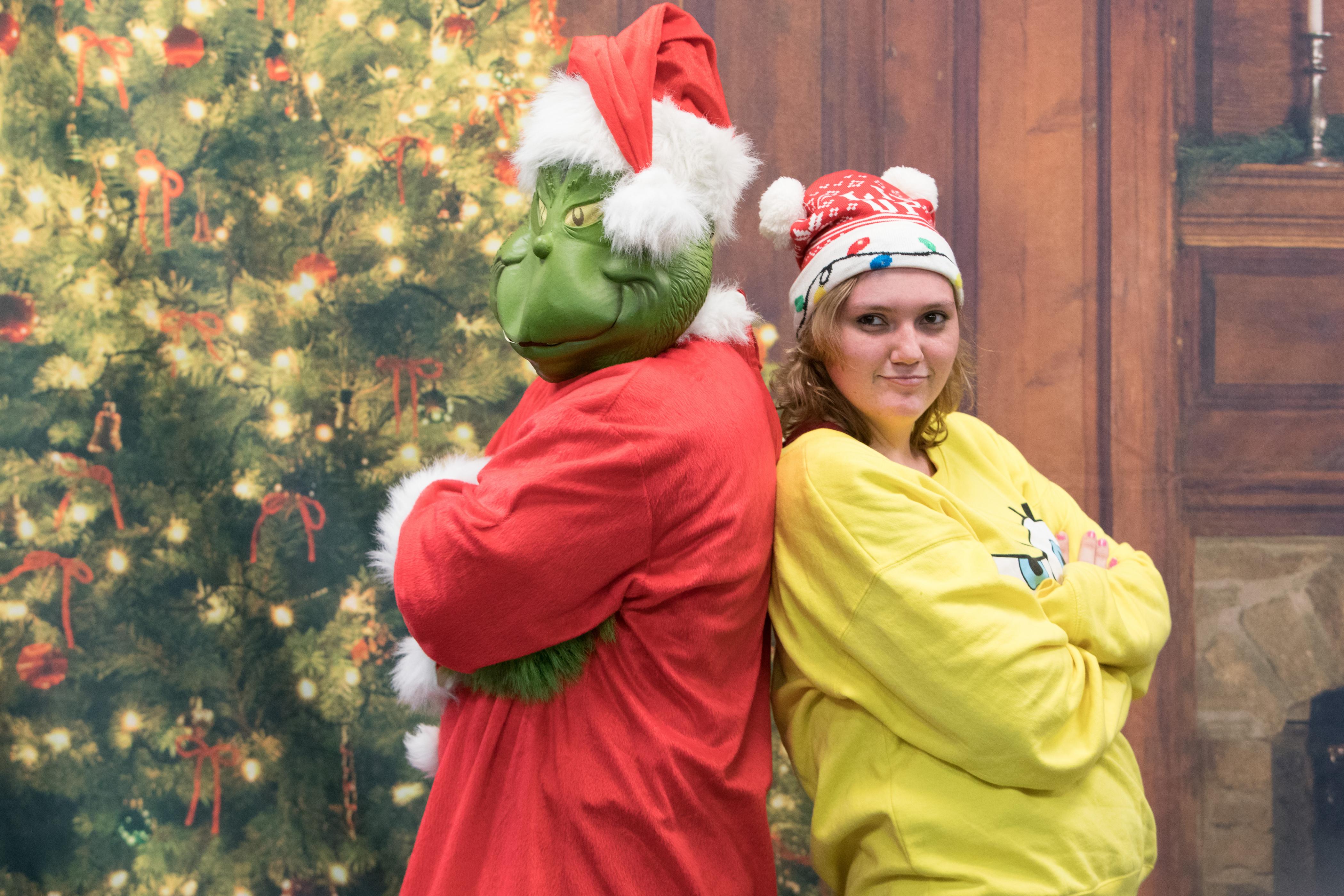 Student poses with the Grinch
