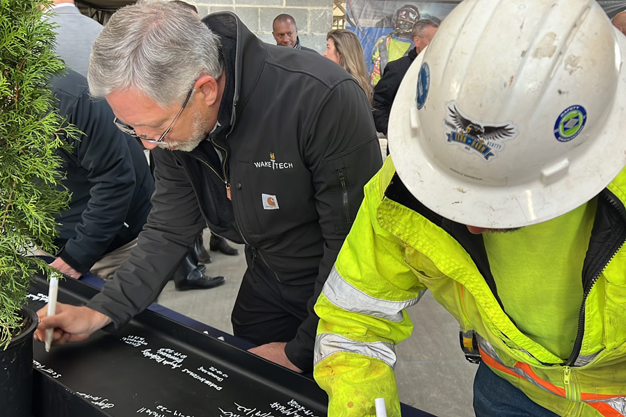 College Holds Topping-Out Ceremony for First Building at Future Campus