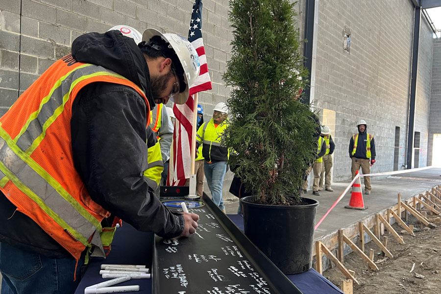 College Holds Topping-Out Ceremony for First Building at Future Campus