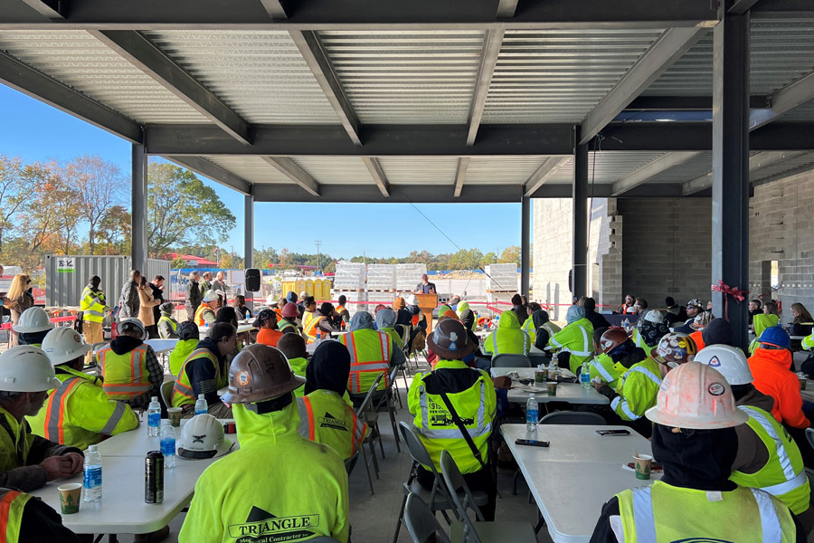 College Holds Topping-Out Ceremony for First Building at Future Campus