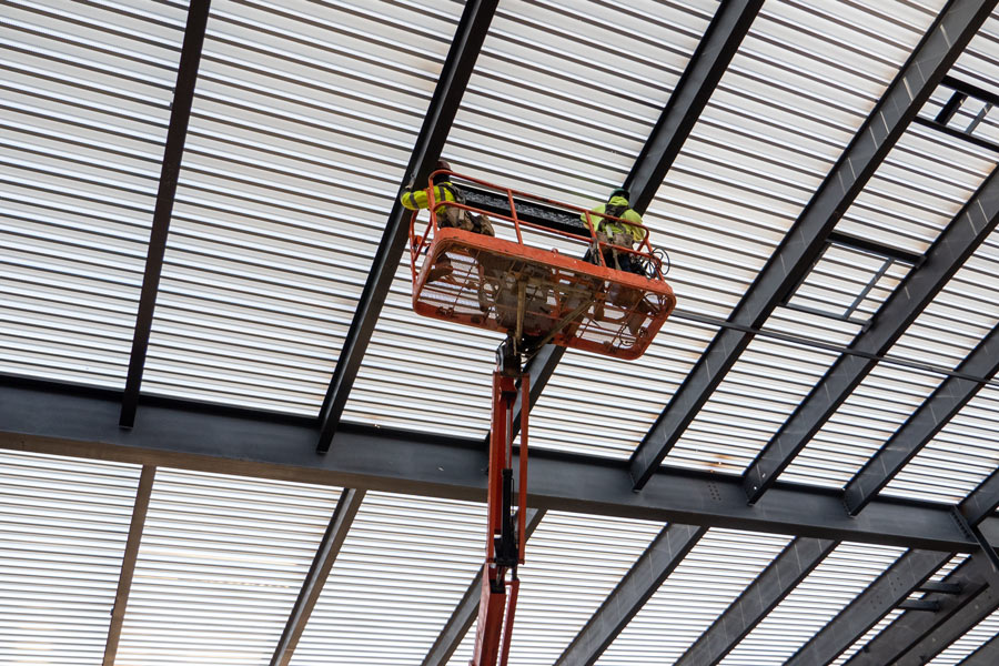 College Holds Topping-Out Ceremony for First Building at Future Campus