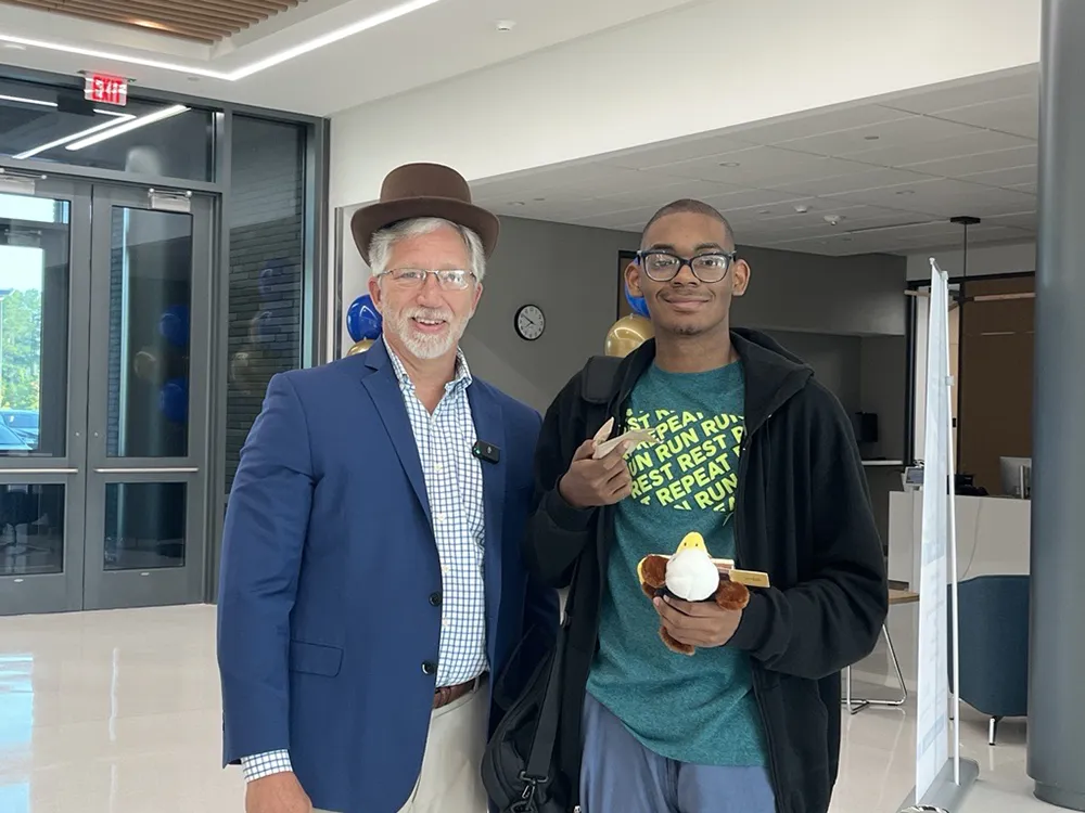 Wake Tech President Dr. Scott Ralls awards a new student with a $250 scholarship on the first day of the 2024-25 academic year.
