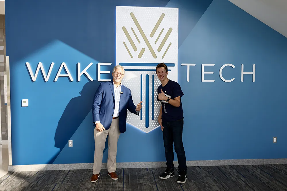 Wake Tech President Dr. Scott Ralls and student body president Silas Johnson celebrate the opening of Wake Tech East on the first day of the 2024-25 academic year.