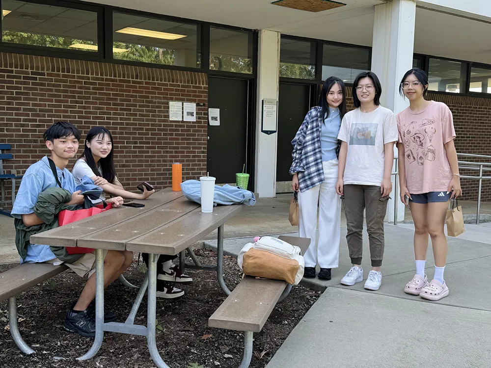 Five Wake Tech students gather on Southern Wake Campus on the first day of the 2024-25 academic year.