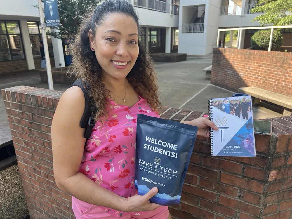 A Wake Tech student shows off swag she received on the first day of the 2024-25 academic year.