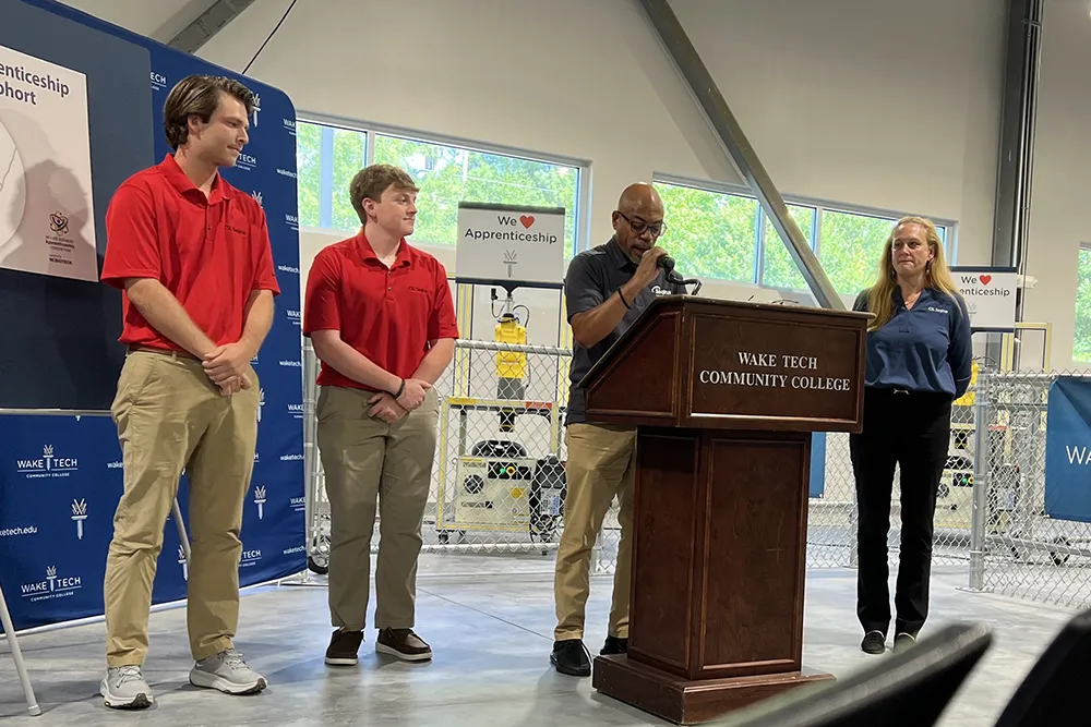 Officials speak during a ceremony marking the launch of Wake Tech's biomechantronics apprenticeship program.