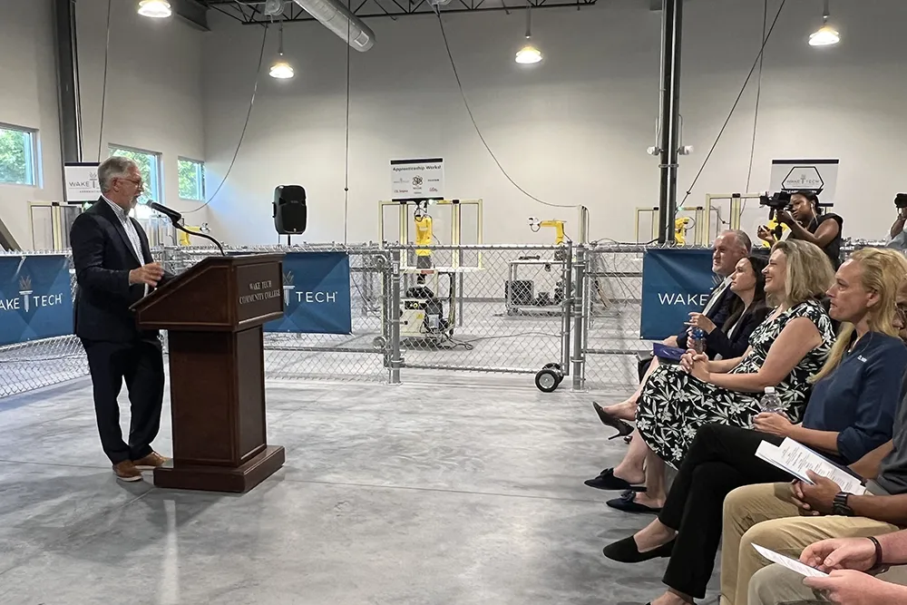 Wake Tech President Dr. Scott Ralls speaks during a ceremony marking the launch of the college's biomechantronics apprenticeship program.