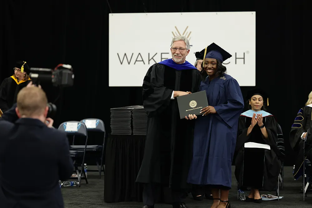 Wake Tech President Dr. Scott Ralls and graduate Aryanah Smith