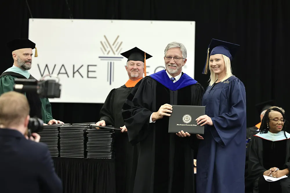 Wake Tech President Dr. Scott Ralls and graduate Alissa Mowery