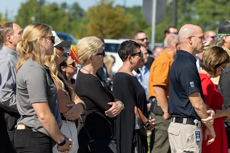 Area firefighters and Wake Tech officials applaud the groundbreaking ceremony for the Advanced Fire and Rescue Training Complex at Wake Tech East.