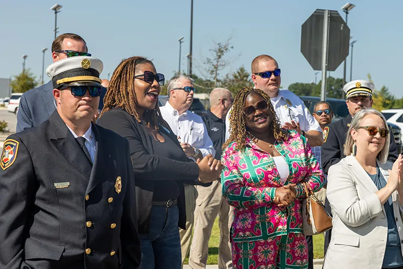 Area firefighters and Wake Tech officials applaud the groundbreaking ceremony for the Advanced Fire and Rescue Training Complex at Wake Tech East.