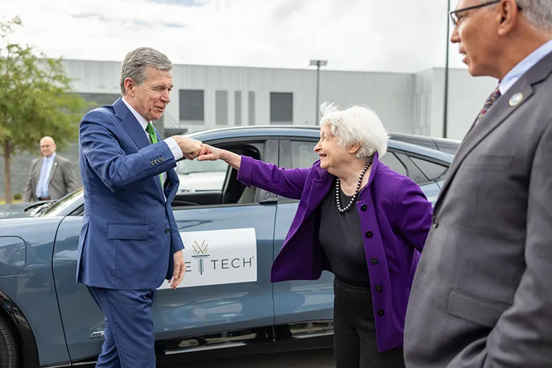 U.S. Treasury Secretary Janet Yellen and North Carolina Gov. Roy Cooper check out at electric vehicle during a visit to Wake Tech East.