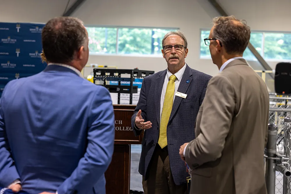 Al Brewer, dean of Engineering, Technologies & Skilled Trades at Wake Tech, speaks with officials after the ceremony announcing the NCAB Broadcast Technology Academy to train radio engineers at the college.